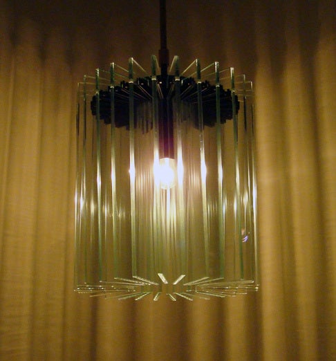 Pendant lamp by Fontana Arte. 28 panes of beveled glass surround single bulb, original canopy. Overall height is 27 inches, glass is 11.75