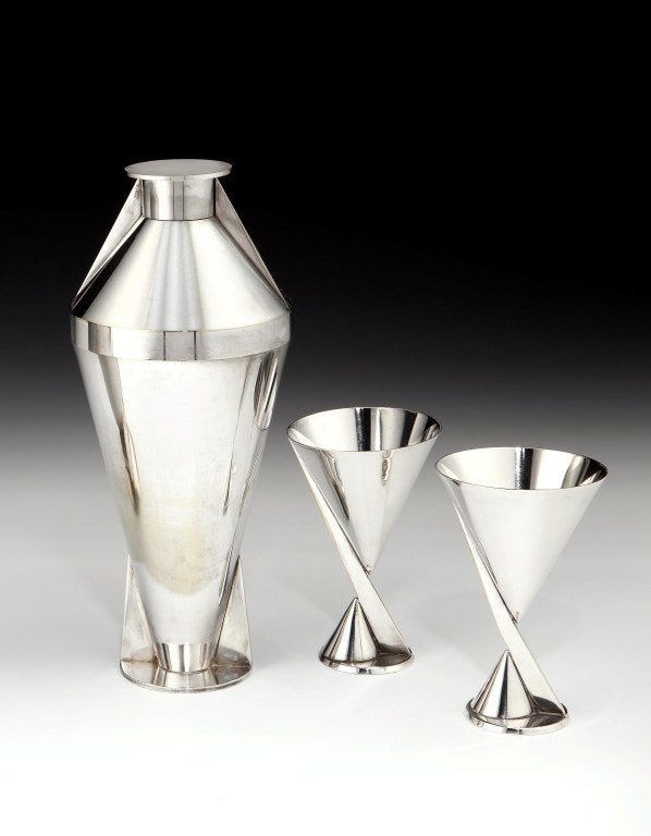 An incredibly rare and important Art Deco cocktail set comprising silver-plated Modernist cocktail shaker and a pair of goblets, each piece bearing maker's marks to the base, all French, circa 1928. <br />
<br />
Height of shaker: 10 inches (26