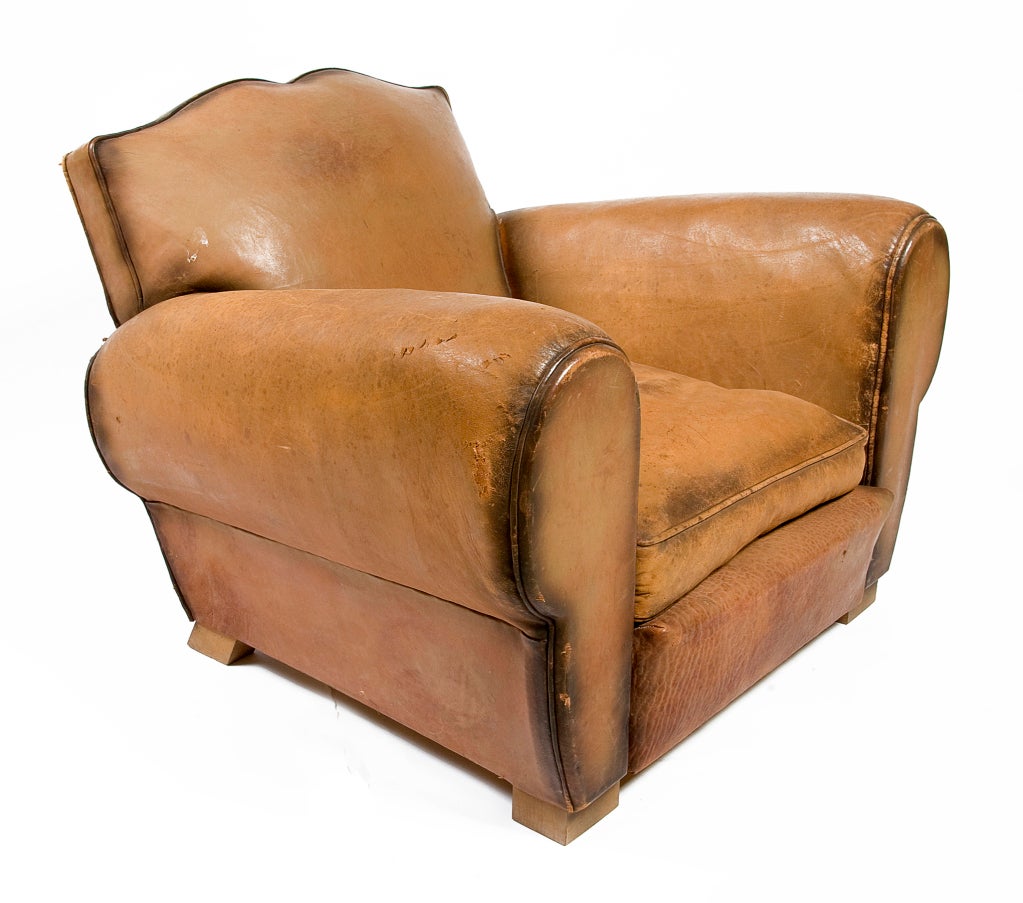 Pair of club chairs with caramel colored leather, beautiful patina, and mustache backs.  Priced as a pair.

Seat Dimensions: 13.5