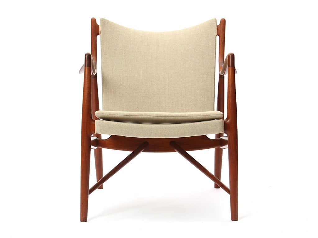 A pair of 45 armchairs with an exposed teak frame and Belgium linen upholstery and natural leather welting.  Designed by Finn Juhl, made by Niels Vodder, Denmark, 1945. 28