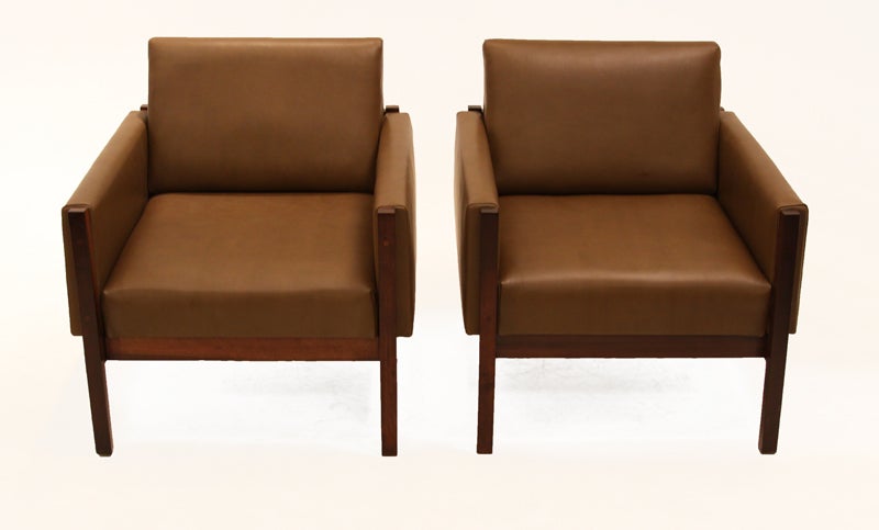 Pair of Baruna wood arm chairs with olive brown leather. Chairs have great seat depth and interesting saps in the wood. The back of these chairs are very constructivist with double bar support.

Seat depth measures 22.5