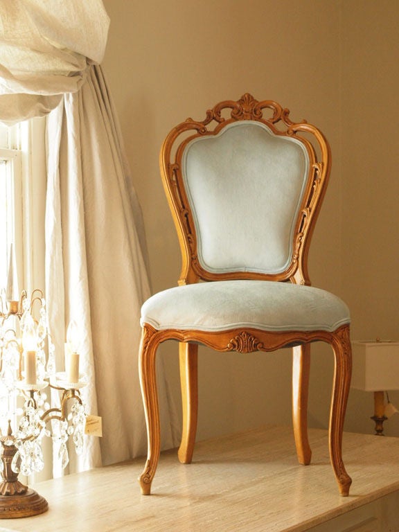 Rare set of 4 French, hand-carved, Rococo Style chairs in blonde walnut.  The detailed hand carvings in these chairs are magnificent and one can only wonder the care and time it took to make these.  Completely restored and reupholstered in a