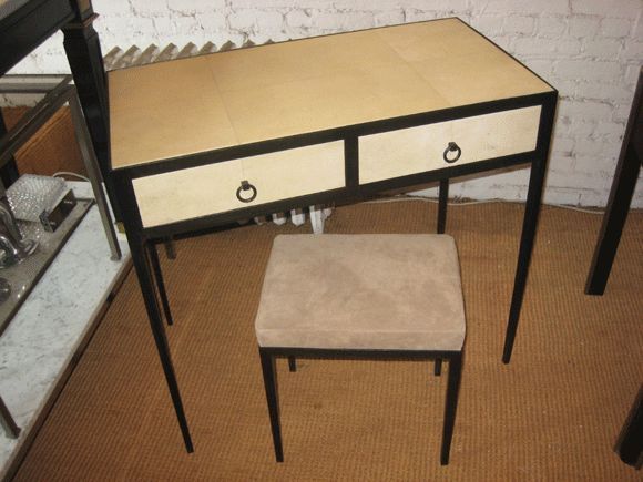 Elegant and Sober French Mid-Century Modern Style parchment covered vanity / desk / console with a lacquered steel frame and utilizing squares of light parchment covering wood. the accompanying stool has a steel frame and suede covered seat.

Custom