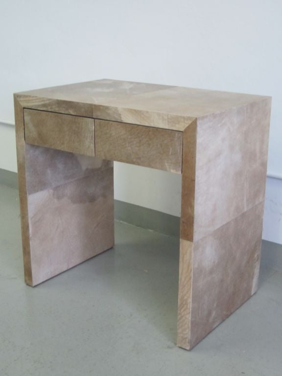 A sober and elegant pair of parchment nightstands / end or side tables designed in the late 20th century in the manner of Jean-Michel Frank. The parchment decoration is arranged large squares of thick sheep and goat parchment. These tables are made