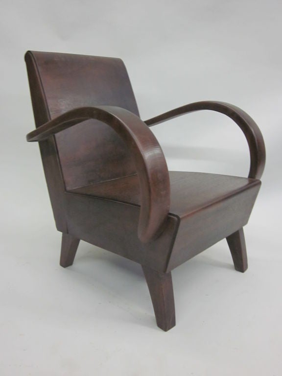 2 Elegant Pairs of French Colonial Lounge / Club Chairs from the Art Deco Period with Curved Arms and Saber Legs. 

Priced individually and sold by the Pair. A Matching Bench and complimentary Cocktail Table are also available (see photos).