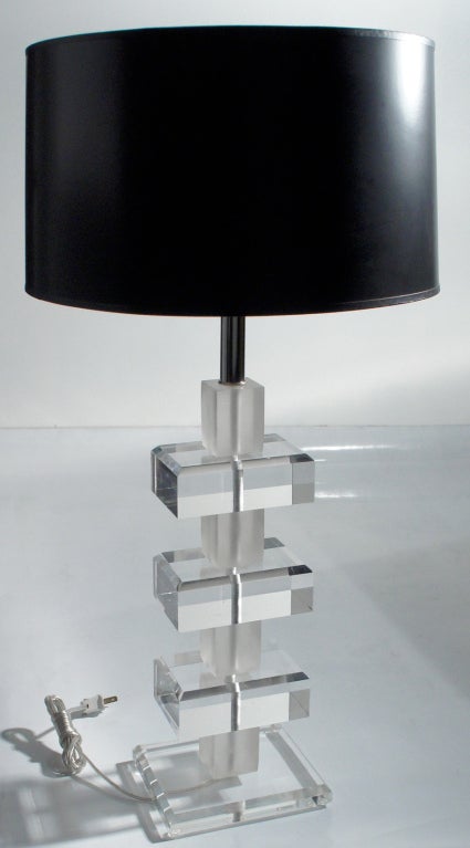 Frosted acrylic cube-forms alternate with clear acrylic chamfered slabs creating prismatic light-effects with this 70's design.  Six by seven-inch Lucite acrylic platform.    Please look for our other Lucite table lamps listed here.