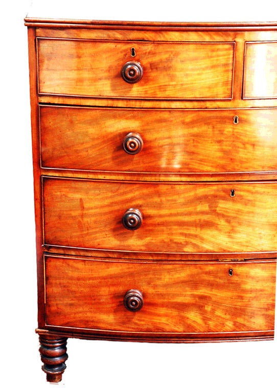 English craftsman used quality imported woods for their specialty and commissioned case goods. This bow front chest was hand crafted in mahogany to showcase the woods beautiful hue and grain. The five drawers are nicely proportioned,  the turned