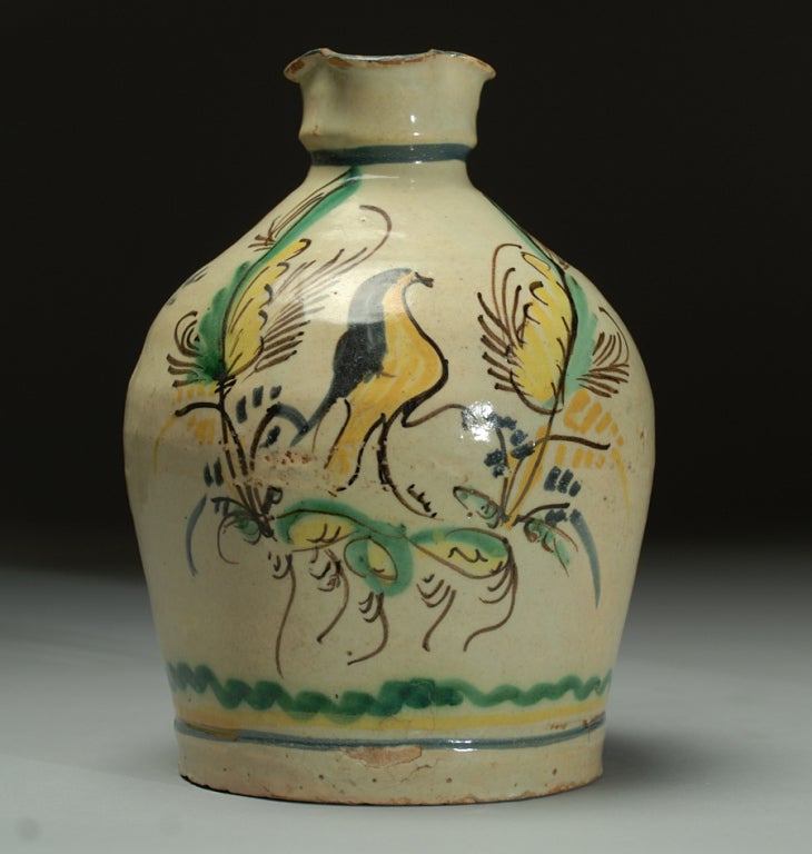 A good 18th century Spanish Jarron with flora and fauna motifs in yellow, black, pale blue and copper green over a milky white slip. 

Dimensions: 9 inches high x 7 inches diameter.