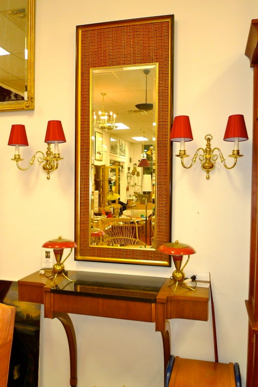The beveled mirror is framed with a dark red and gold woven fabric with a black and gilt frame. 

Original LaBarge label on back of mirror.

Mirror dimensions: 58