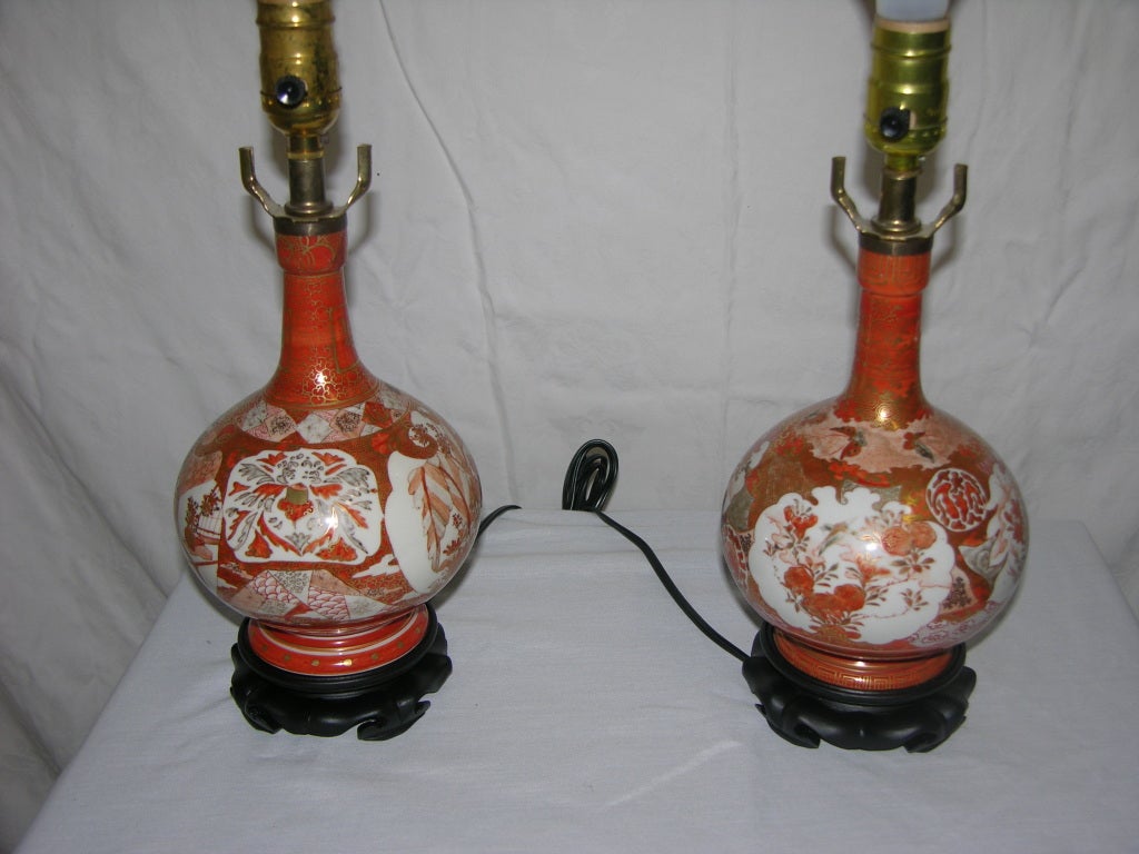 Exceptional pair of late Kutani vases,with brilliant red and gold overglaze and the characteristic use of dull black,converted to small lamps. The surfaces are intricately detailed with cartouches of figures in scholarly pursuits and domestic