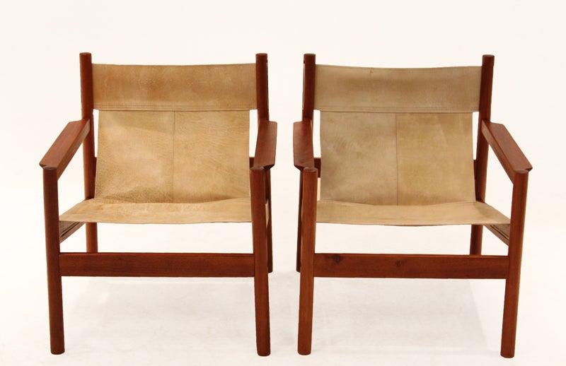 Pair of Roxinho wood and leather sling chairs by Michel Arnoult. The leather is in beautiful aged condition with white stitching.
Many pieces are stored in our warehouse, so please give us a call at (323) 463-4434 or email us at