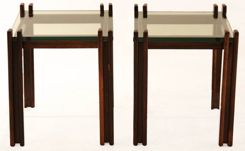 Two rectangular side tables from Brazil with solid rosewood base and a cantilevered thick glass inset into the base posts.

In order to preserve our inventory, after restoration we blanket wrap and store nearly every piece in our warehouse. Please