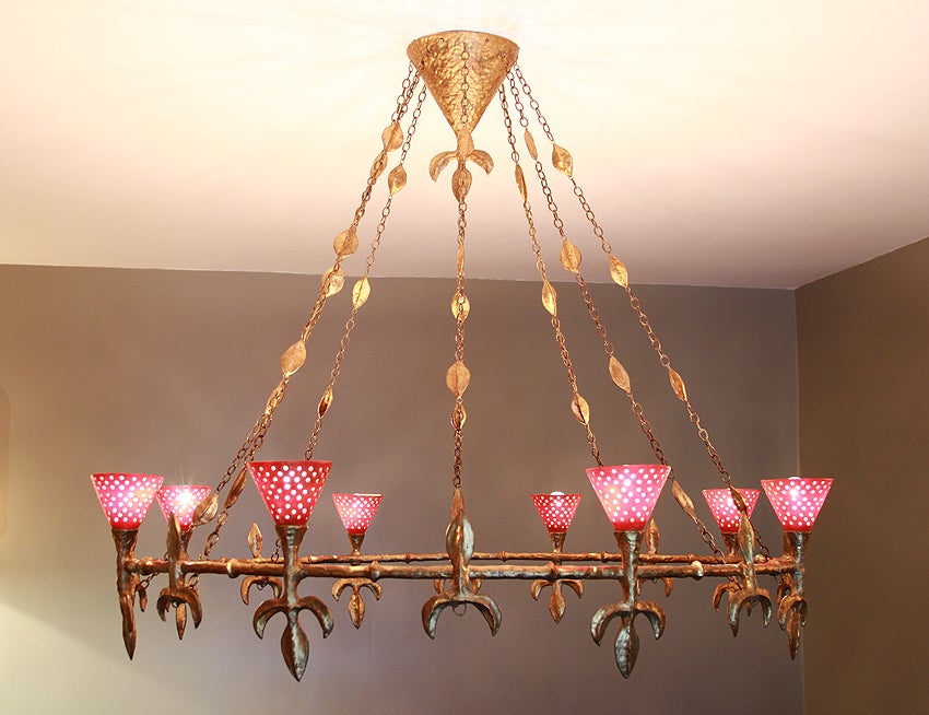 Large chandelier with eight lamps in gold and copper leaf iron thread and resin composite by COUTANT. The piece is signed.

Only two copies of this chandelier were made for the restaurant.
The wiring has not been changed, only the socket threads