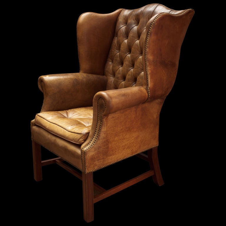 Leather tufted library chair with original leather, slight roll arm with wingback sides.