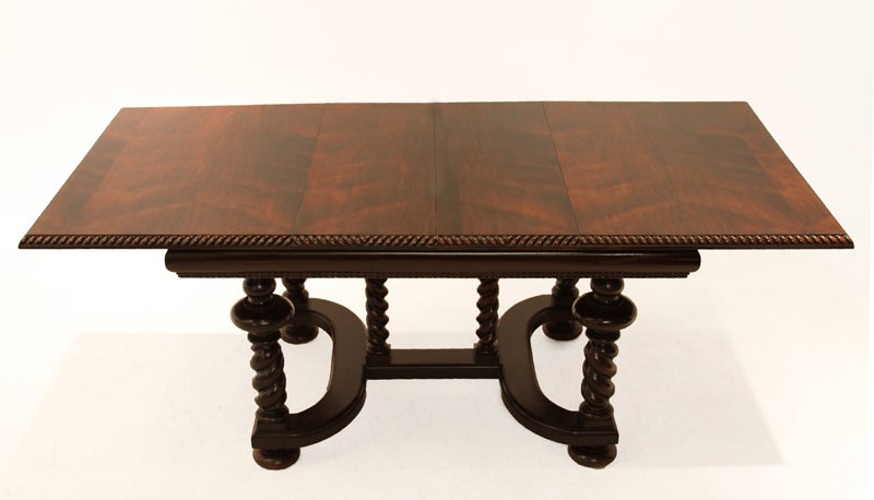 This rosewood dining table has beautiful banding and an ornately carved base and two leaves. Measurements below reflect the table with the leaves. Without leaves the table measures 55.5