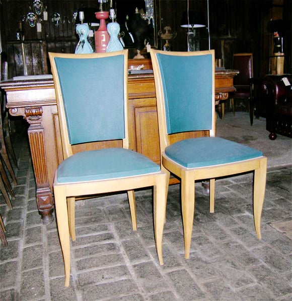 Upholstered high back sycamore chairs with tapered legs.