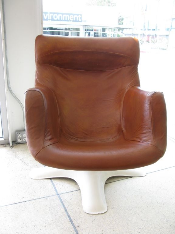 Original Karuselli rocking & swiveling armchair designed Yrjö Kukkapuro.  Manufactured by Haimi of Finland.  White fiberglass base and seat shell with a chromed steel center support.  Upholstered in original beautiful camel colored leather.  Seat