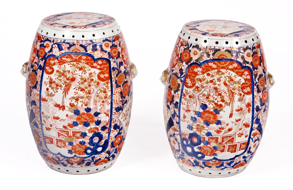 Rare pair of mid 19th century Chinese porcelain garden seats in Japanese Imari style with foliate, peacock and foo dog decoration.