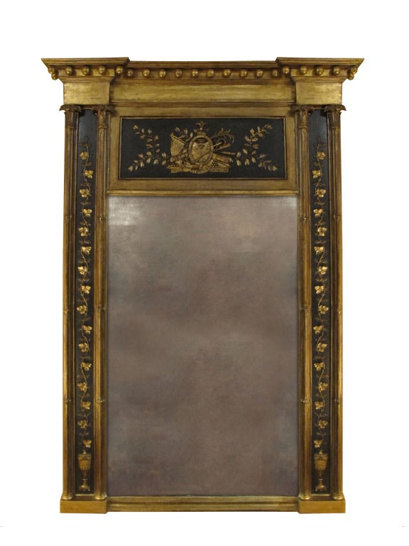 # P551 - Regency painted and carved giltwood mirror attributed to Fentham, Strand, London. The rectangular beveled plated flanked by pilasters enriched with carved foliate details. The pediment centering a plaque with 'Nelsons' arms below a stepped