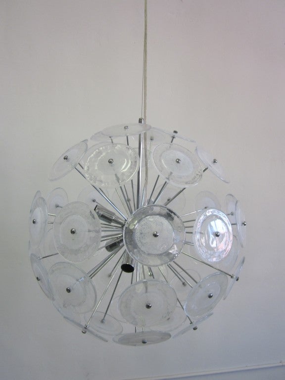 Two Pairs of elegant Italian Mid-Century Modern style pendant fixtures composed of handblown Murano glass discs in clear glass with a white glass center mounted on a chrome fixture arranged in a ball form. Normal size is about 20 x 20 and contains