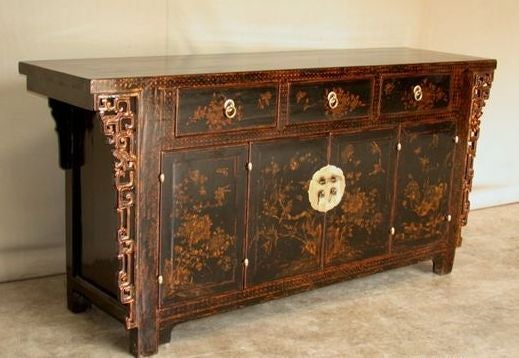 A refined and elegant black lacquer sideboard with hand painted gold gilt motif on the pair of bifold doors and three drawers, brass fitting, beautiful color, form and lines. Visit our website at: www.greenwichorientalantiques.com for additional