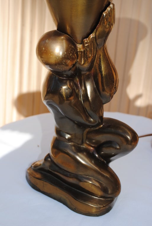 A pair of masculine Bronze Nude Figurines of grandeur-grasping cone-like shades of torchieres.Massive sculptured forms like Atlas,worked beautifully in bronze toned copper.All original,but recently rewired,classic Art Deco.