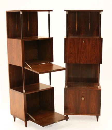 Two vertical Rosewood bars that could also be used as cabinets custom-made by Joaquim Tenreiro. There is display space for bottles or books and tapered Rosewood feet. Each cabinet features a pair of vintage lock boxes with prominent grain which are