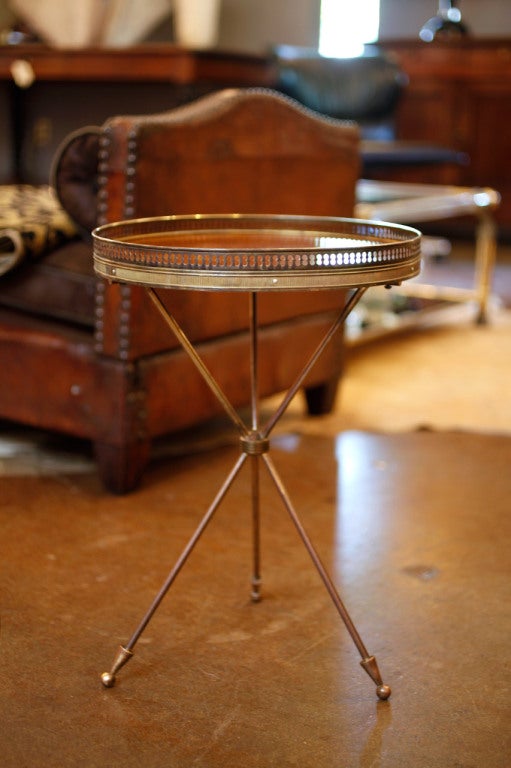 French antique brass tripod table with mahogany top. A classic piece by Jansen.