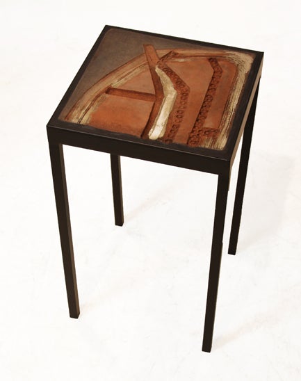 Unique ceramic tile side table with a solid metal table base with a flat black polish. The ceramic tile is high fired stoneware. This tile was designed by Marcel Hoessly for Western Quarry Tile. This table is part of a larger collection as shown in