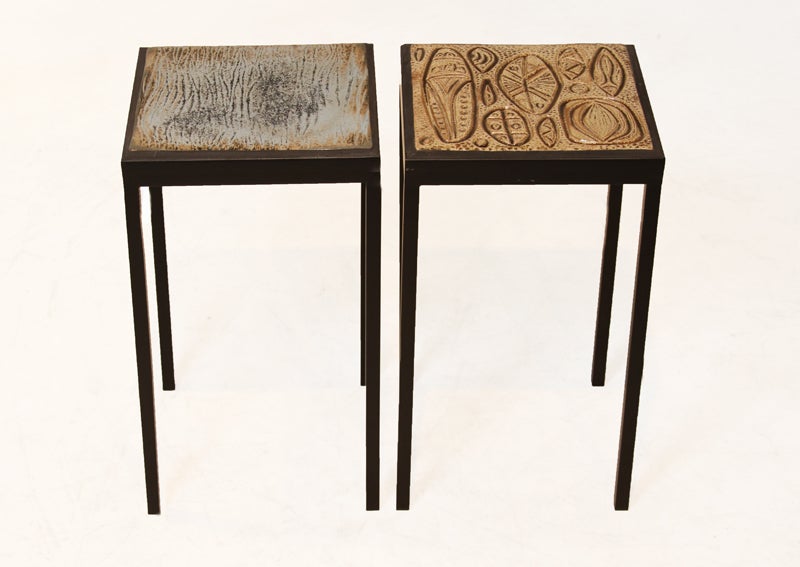 Set of two unique glazed ceramic tile side tables with a solid metal table base with a flat black polish. These ceramic tiles are high fired stoneware. These tiles were designed by Marcel Hoessly for Western Quarry Tile. They are priced individually