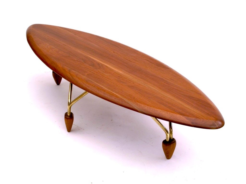 John Keal for Brown Saltman rare and important surfboard coffee table and two-tier side table.  Beautiful grain, flamed wood gracefully shaped. Brass legs are anchored with  wooden feet.   Fully restored tops.

Coffee table:  60