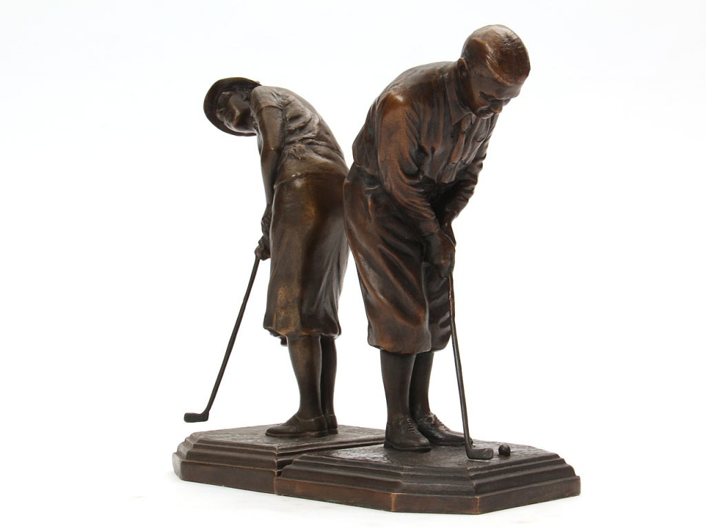 A pair of bronze bookends in the form of golfing couple Bobby Jones and Glenna Collett. Created for the 1932 Olympic Games. Marked 
