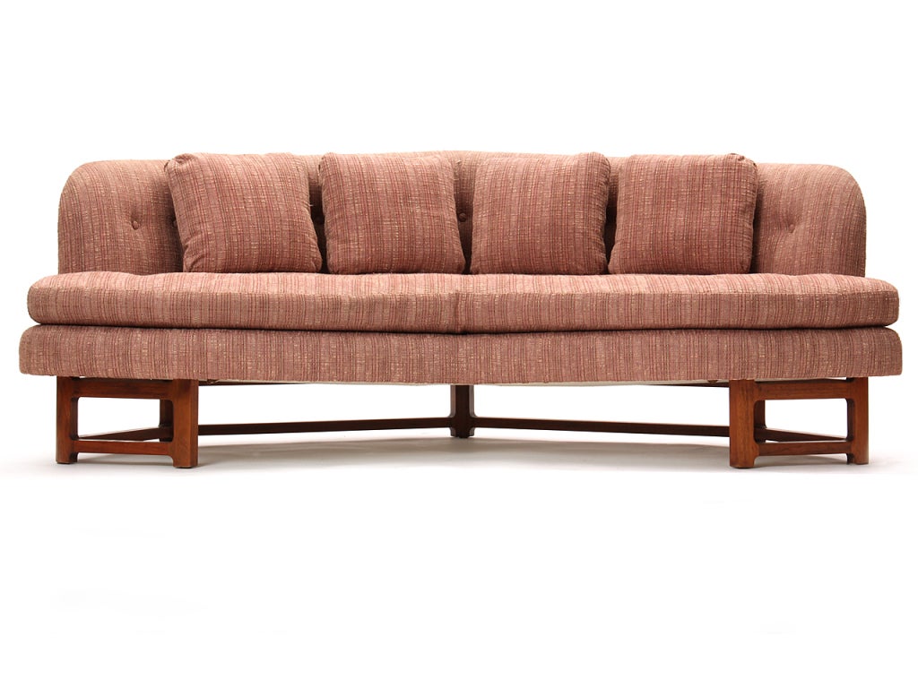 An angled 'Janus' sofa on a walnut frame base in original pink upholstery. Each 'wing' is 43.5