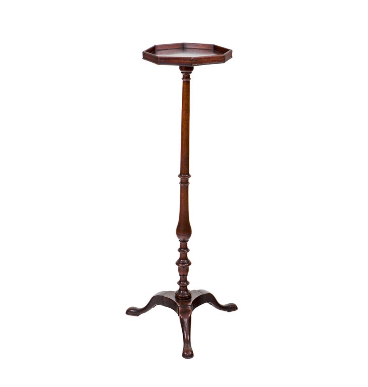 Mahogany candlestick stand with octagonal top on tripod base.