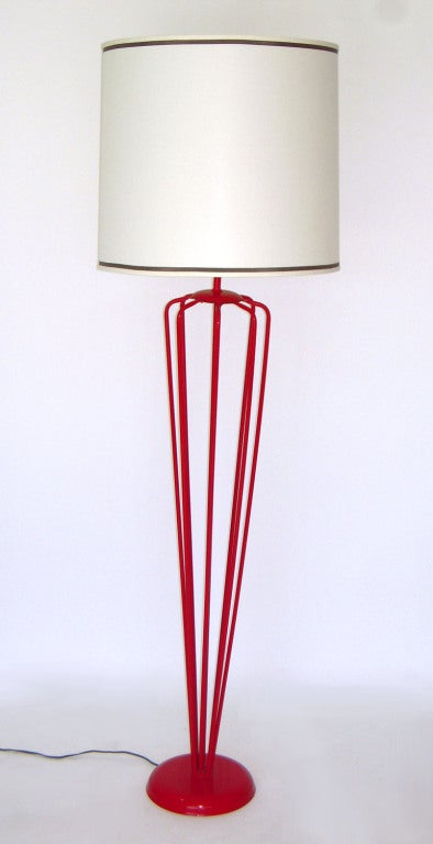 Substantial open frame, iron-work, floor lamp with red lacquer and large white drum shade.