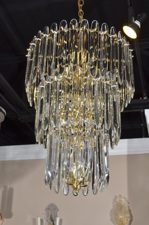 Large and impressive 3-tier crystal chandelier by Gaetano Sciolari. Gorgeous shaped crystals on brass plated frame.