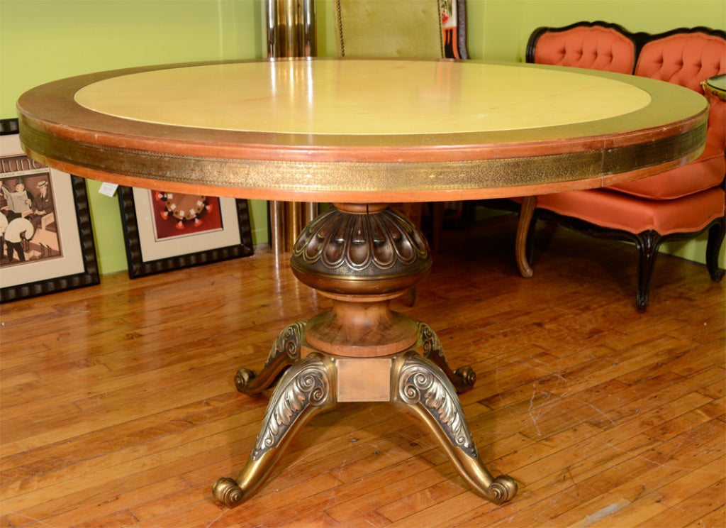 An Italian center table with an inset marble surface. There is a elaborate brass band around the edge and the base and legs are covered in chrome overlay.

Reduced From: $4750