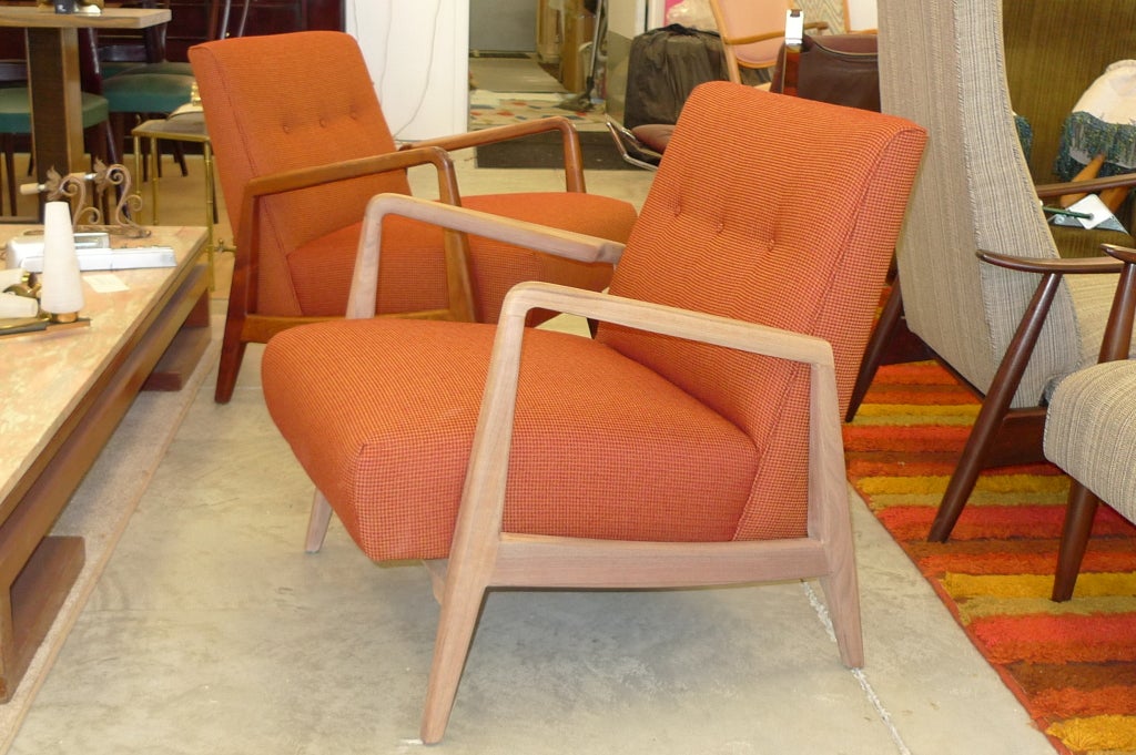 A hard to find original pair of Jens Risom lounge chairs with sculptural walnut frames.  Label 'Jens Risom Designs'.  

Price is for the pair.