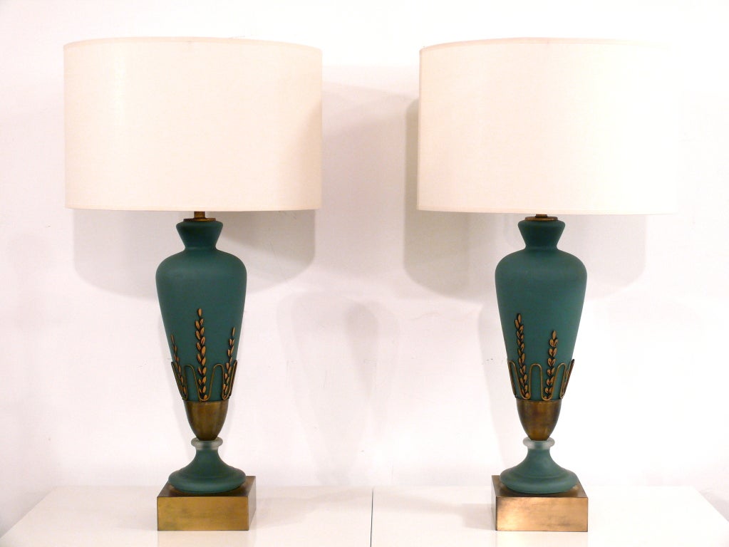 Pair of glass lamps with metal leaf accents. Bluish green color. Shades not included