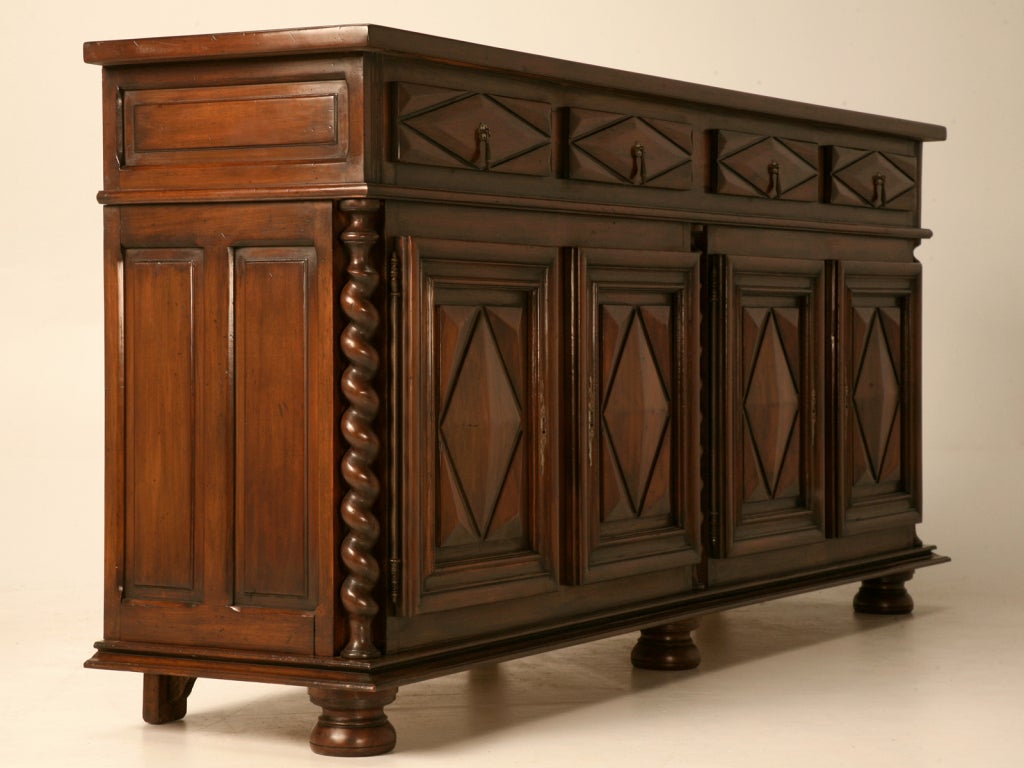 Spectacular vintage French Louis XIII style 4 drawer over 4 door walnut buffet. True to style, this fine buffet has many great Louis XIII characteristics, diamant cut patterns on the front, barley twist trim, and flattened bun feet. Other notable