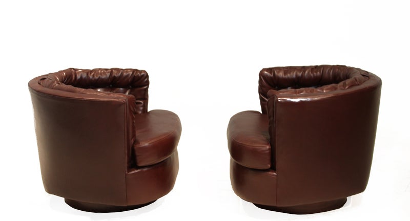 American Pair of leather tufted barrel swivel chairs by Milo Baughman