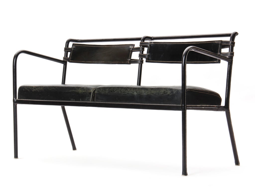 A leather wrapped tubular steel framed settee/bench with black leather upholstered seat and buckled sling back,