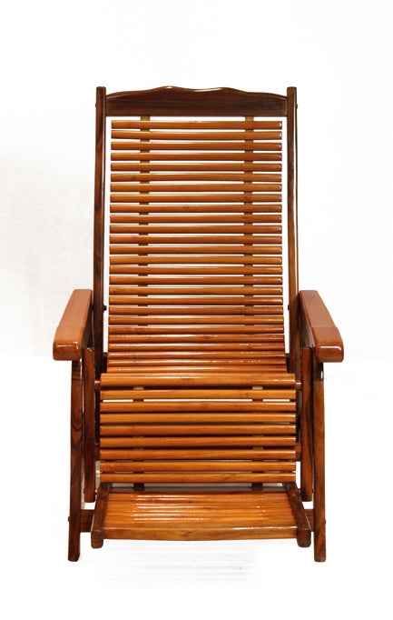 Brazilian slatted lounge chair that extends back for ultimate comfort. The chair base is solid Brazilian exotic hardwood with Pau Ferra arms and slatted seat. The slats are attached to two leather straps to give the seat a sling or hammock feel.