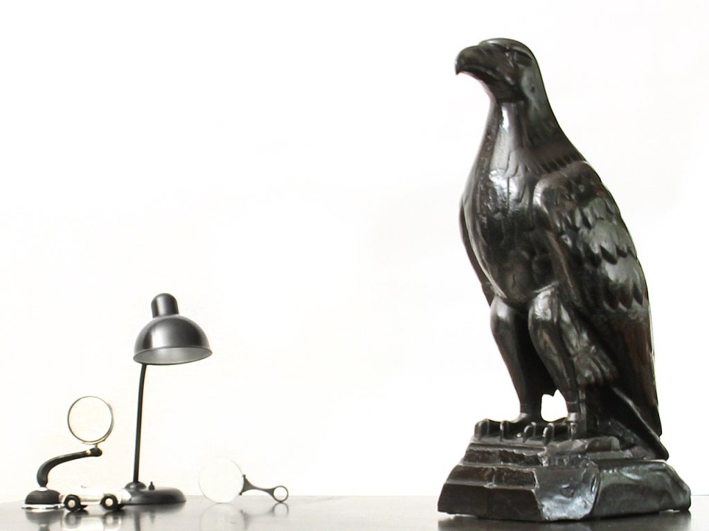A white Eagle Gas Co. antique cast iron eagle sculpture.