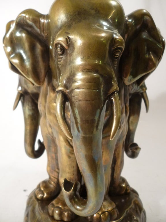 Novelty Ceylanese Bronze Elephant Lamp, stamped by Makers: M.P Kirihary, Muhandrum, Madwela.
The Lamp depicts the head and legs of three Elephants with their bodies morphed into one, it is realistically sculpted. 
Wired UK.
(not including shade)
