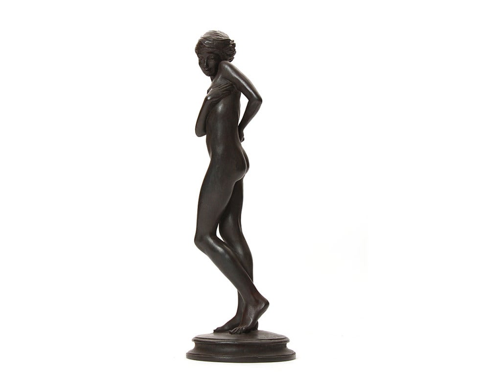 Une élégante sculpture en bronze d'un sujet féminin nu, signée E. Mellon.