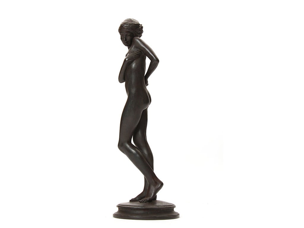 Un'elegante scultura in bronzo di un soggetto femminile nudo, firmata E. Mellon.
