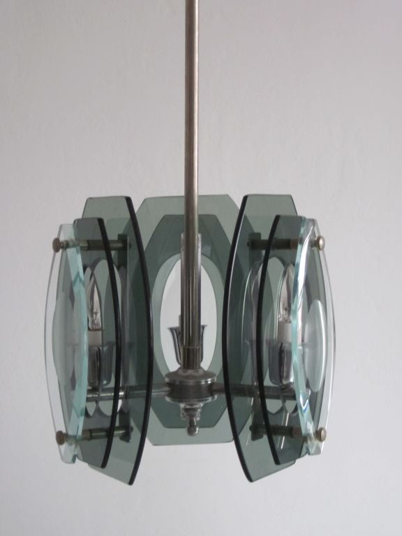 Italian Mid-Century Modern smoked and green glass pendant, lantern or chandelier in the style of Max Ingrand and Fontana Arte. 

The three-light fixtures has each lighting element encased by three successive layers of glass, the two inner levels