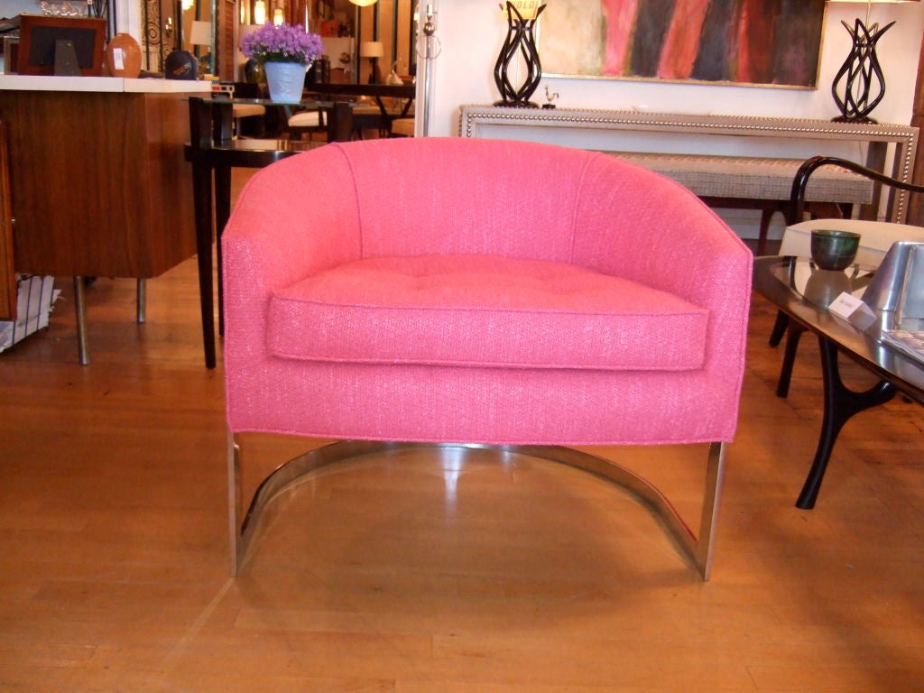 Singe hot pink Milo Baughman Style Barrel Chair.  Chrome U frame lifts up the hot pink seat.  Hot pink buttons accent the chair and the frame.