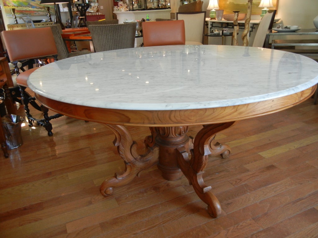 Large hand carved country French Walnut circular dining room table.Center pedestal supporting four curvaceous and well detailed legs,beautiful French Walnut woods (solid) Beveled  bianca carrara white marble top,seats 6 easily and eight if
